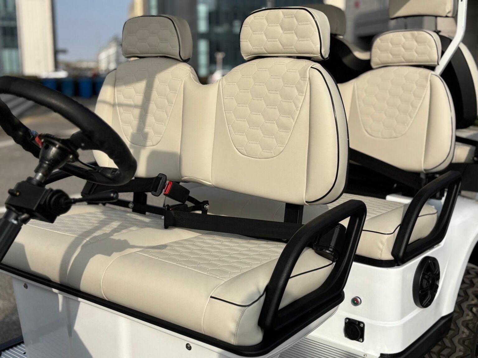 White 4 plus 2 passenger electric golf cart with premium seats